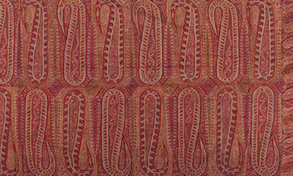 Shawl embroidered with two rows of elongated paisley motifs arranged lengthwise, flanked by a border of smaller paisleys.