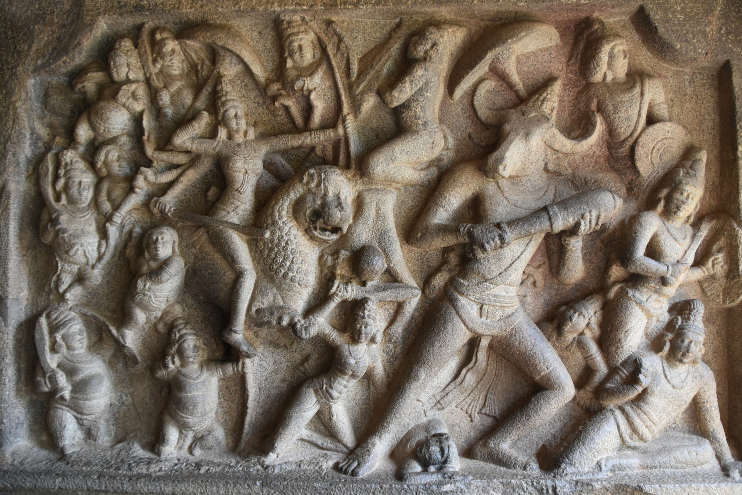 Photograph of a relief sculpture depicting Mahishasuramardhini on a lion shooting an arrow at the demon Mahishasura at the Mahishasuramardini Cave Temple in Mamallapuram