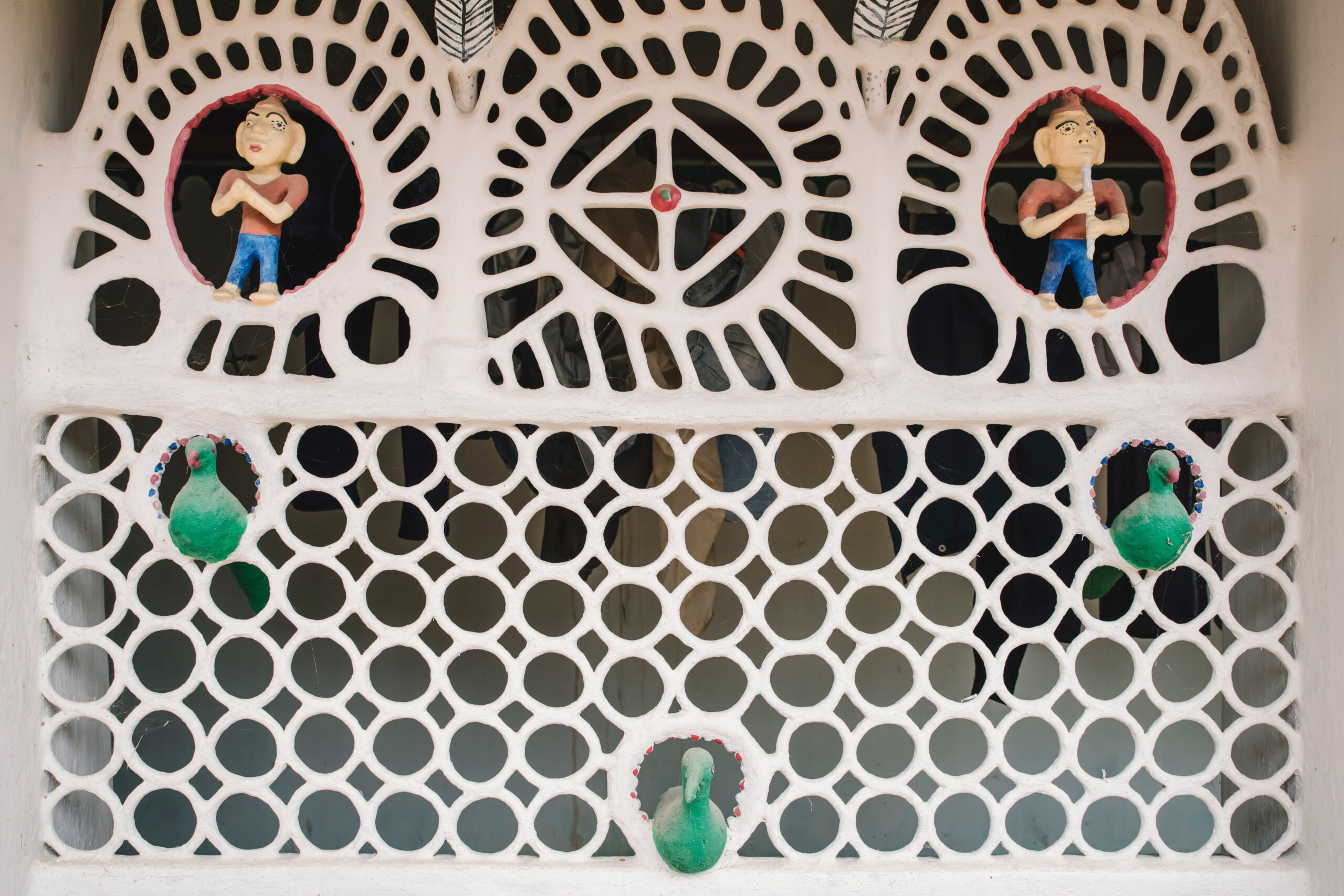 Photograph by Suleiman Merchant showing the wall of a house with lattice work in clay relief