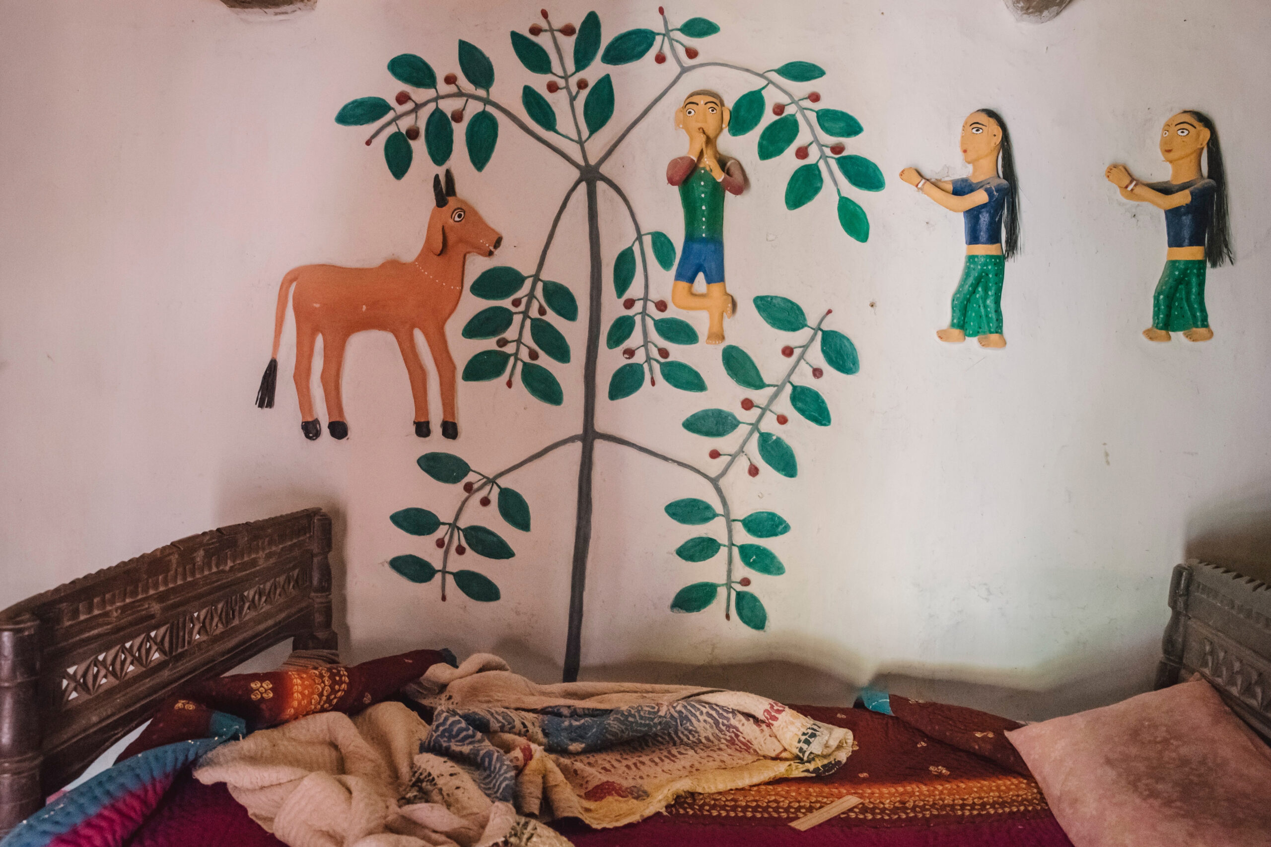 Photograph by Suleiman Merchant of a clay relief mural inside a bedroom