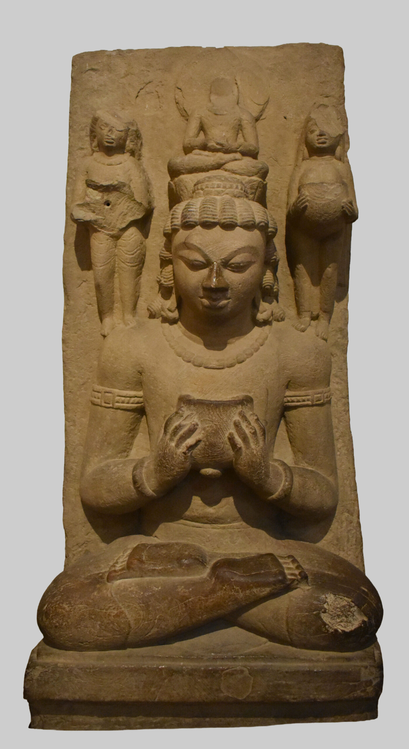 Photograph of a seated sandstone Avalokiteshvara from Sarnath holding a bowl dated between the 5th & 6th century