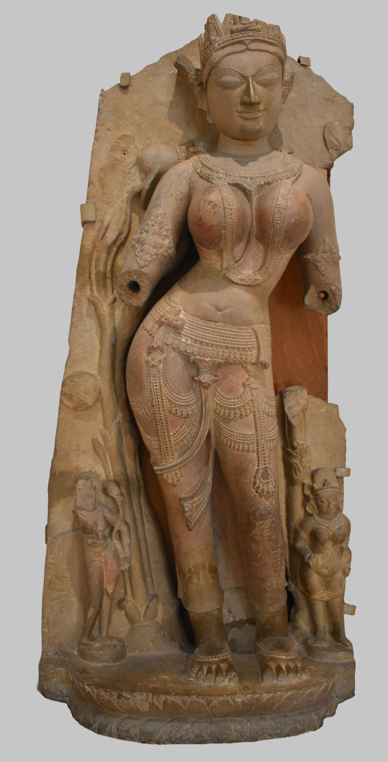 Photograph of a standing sandstone Tara from Sarnath with both its hands broken dated to the 11th century