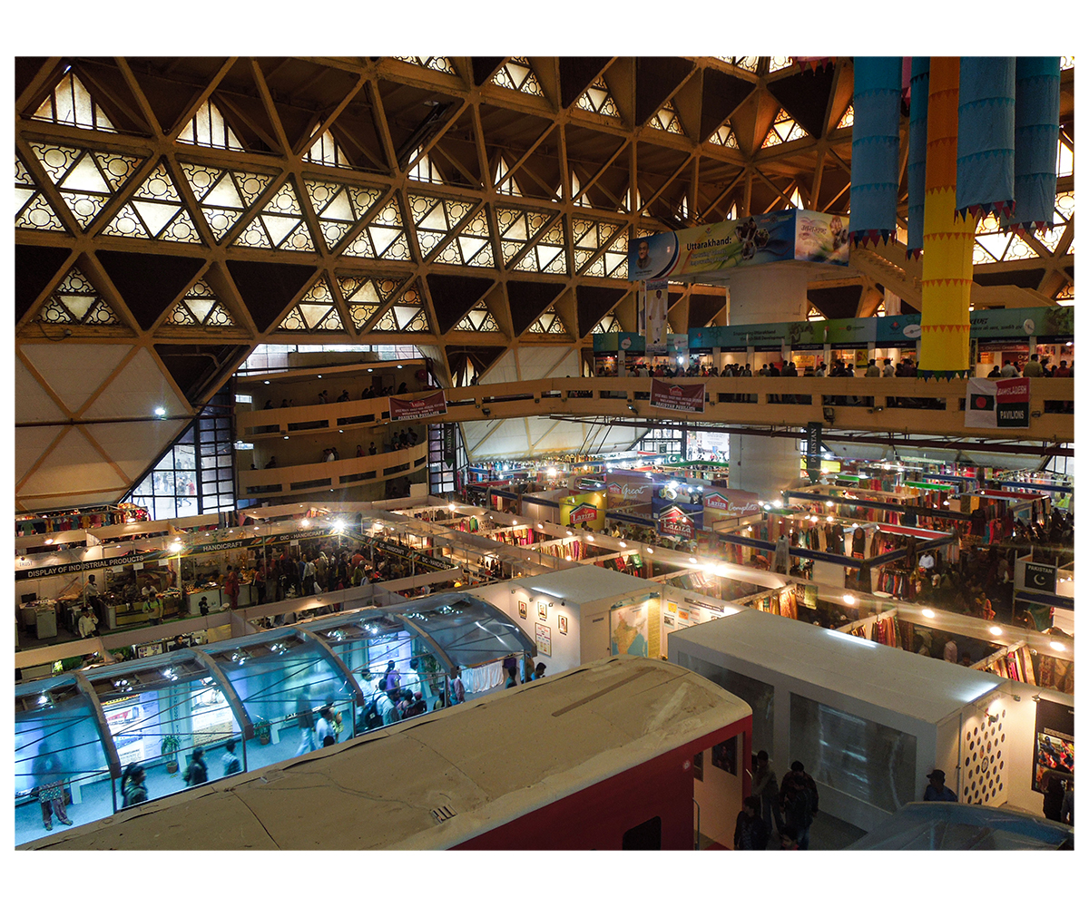 Photograph showing Hall of Nations interior with people and stalls during 2012 India International Trade Fair