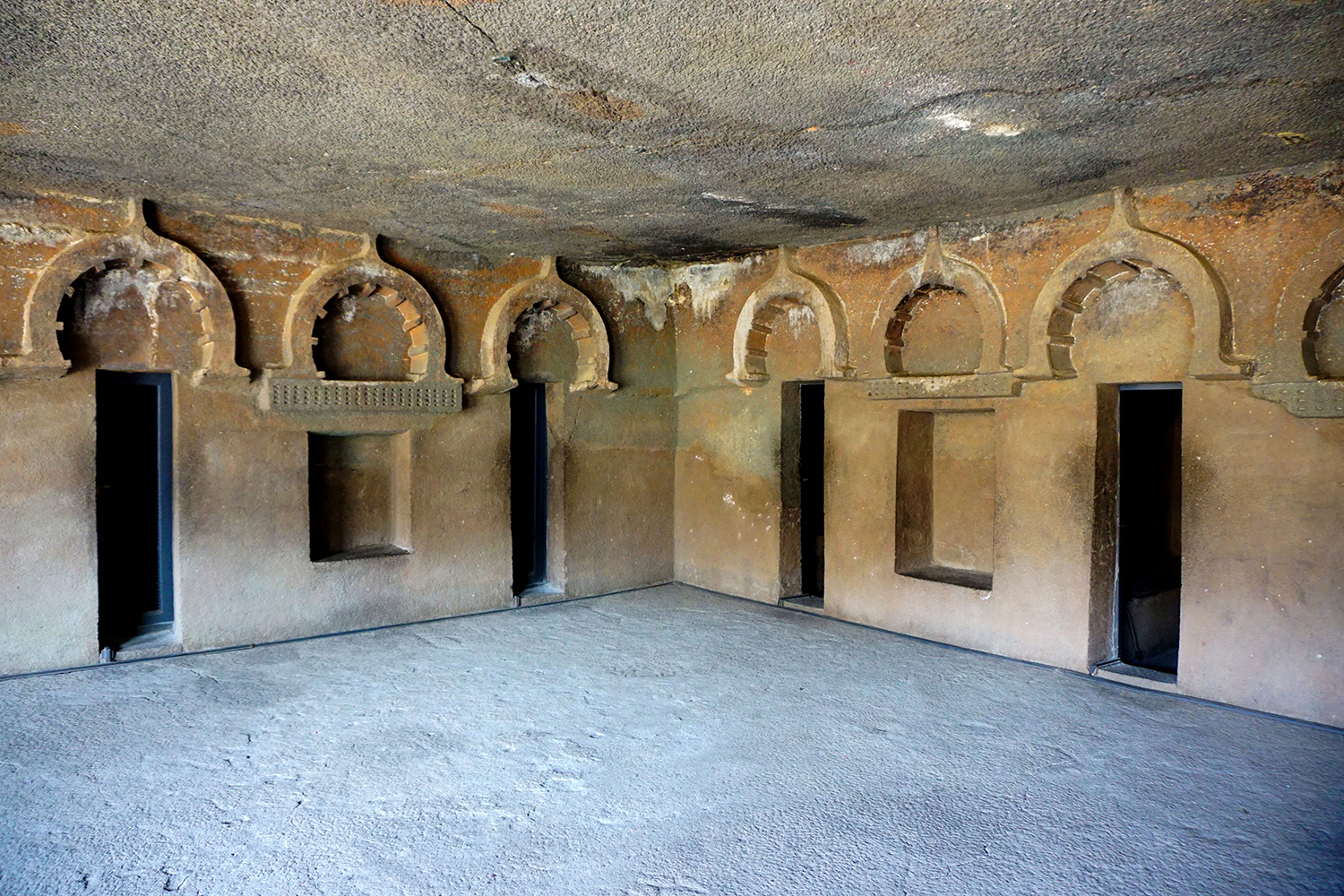 Photograph showing entrances to four vihara cells at Cave 12 of Ajanta Caves