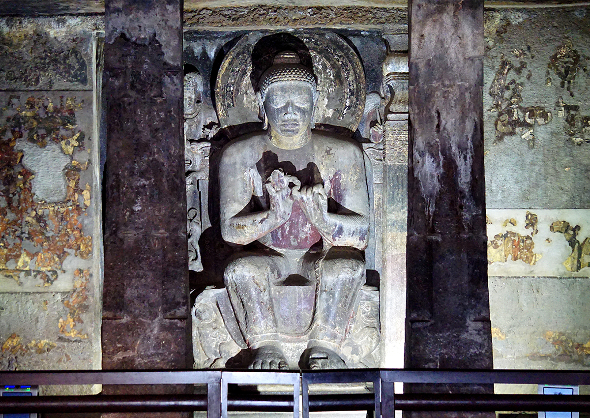 Photograph of the main shrine at Ajanta Cave 16 showing a seated Buddha in the Dharmachakra Mudra