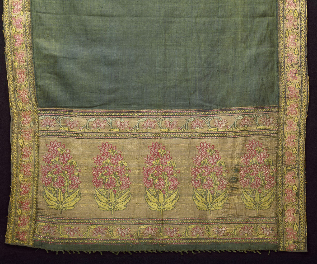 Photograph (detail) of Mughal patka in green silk, with borders and end panel showing flowering plants