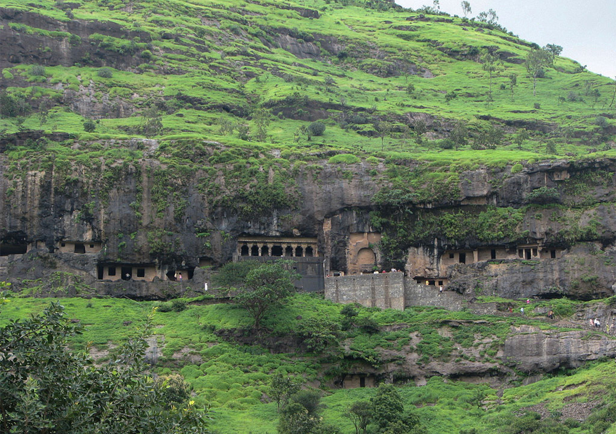 Photograph showing the Ganesh Lena Caves in the hillside at Ellora