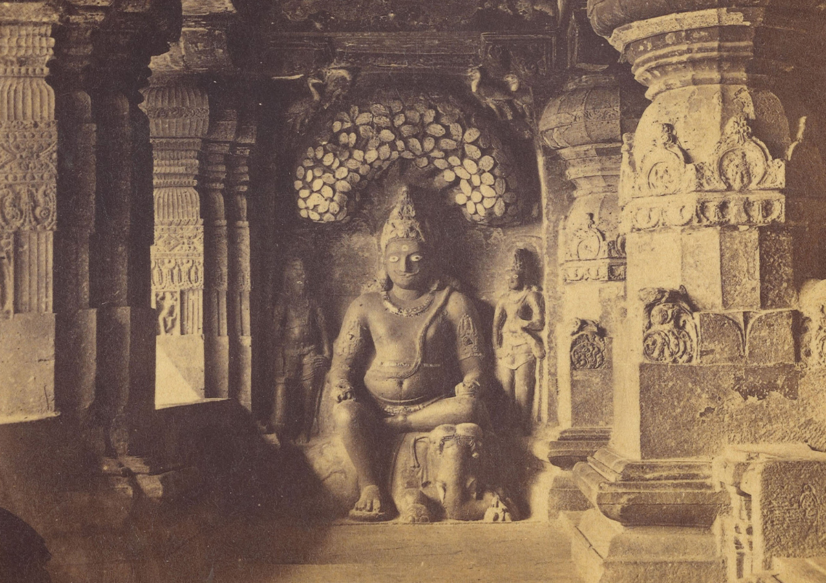 Albumen print of a pillared hall at Ellora's Indra Sabha Cave, with relief of figure seated on elephant, flanked by two smaller standing figures