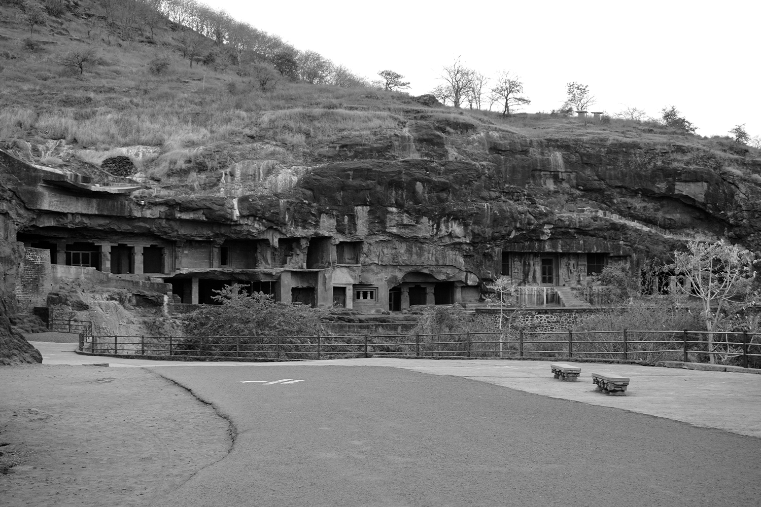 Photograph of Caves 1 to 9 at Ellora in the hillside, seen from a distance