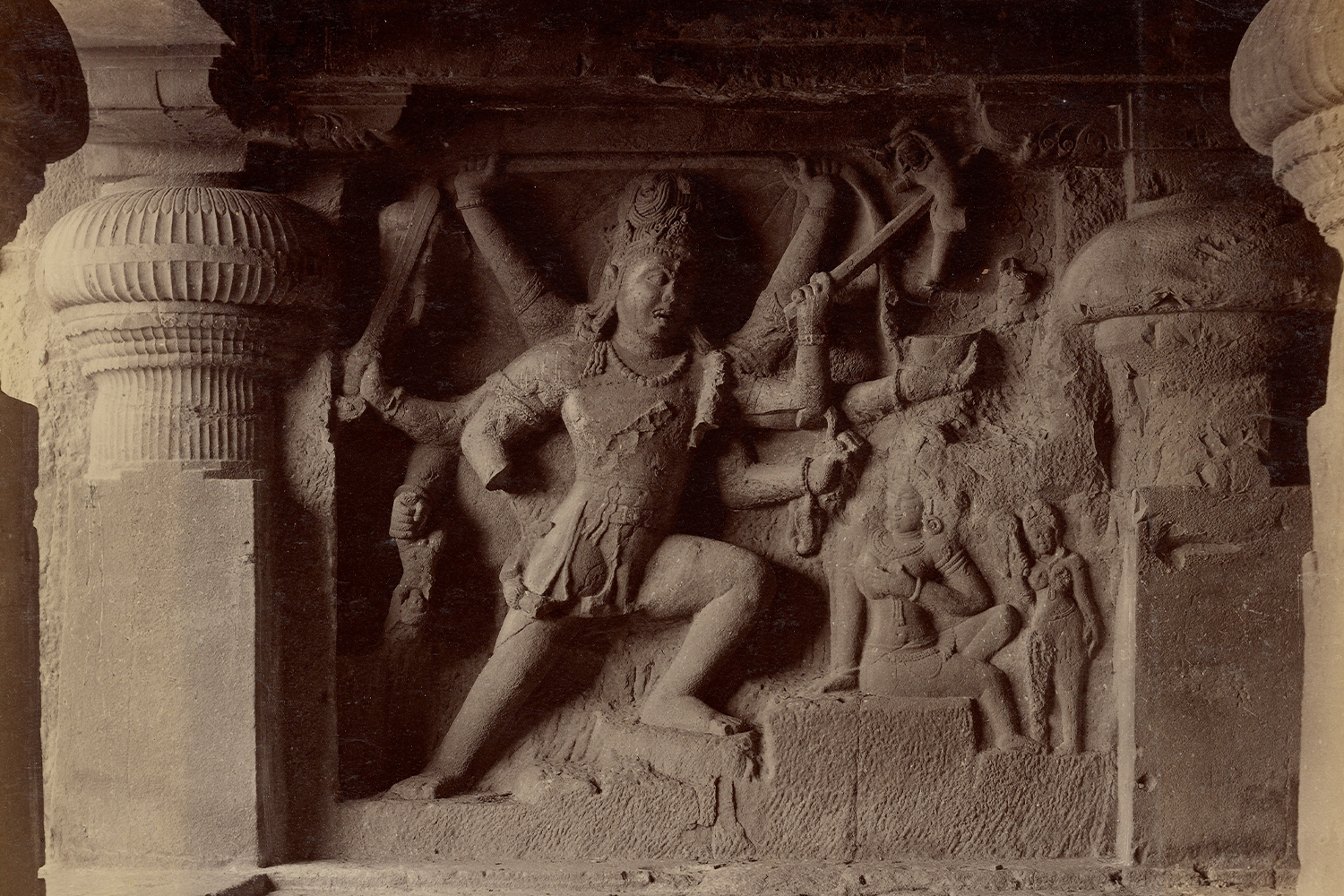 Monochrome albumen print by Lala Deen Dayal showing high-relief carving of Virabhadra between pilasters at Ellora Cave 29