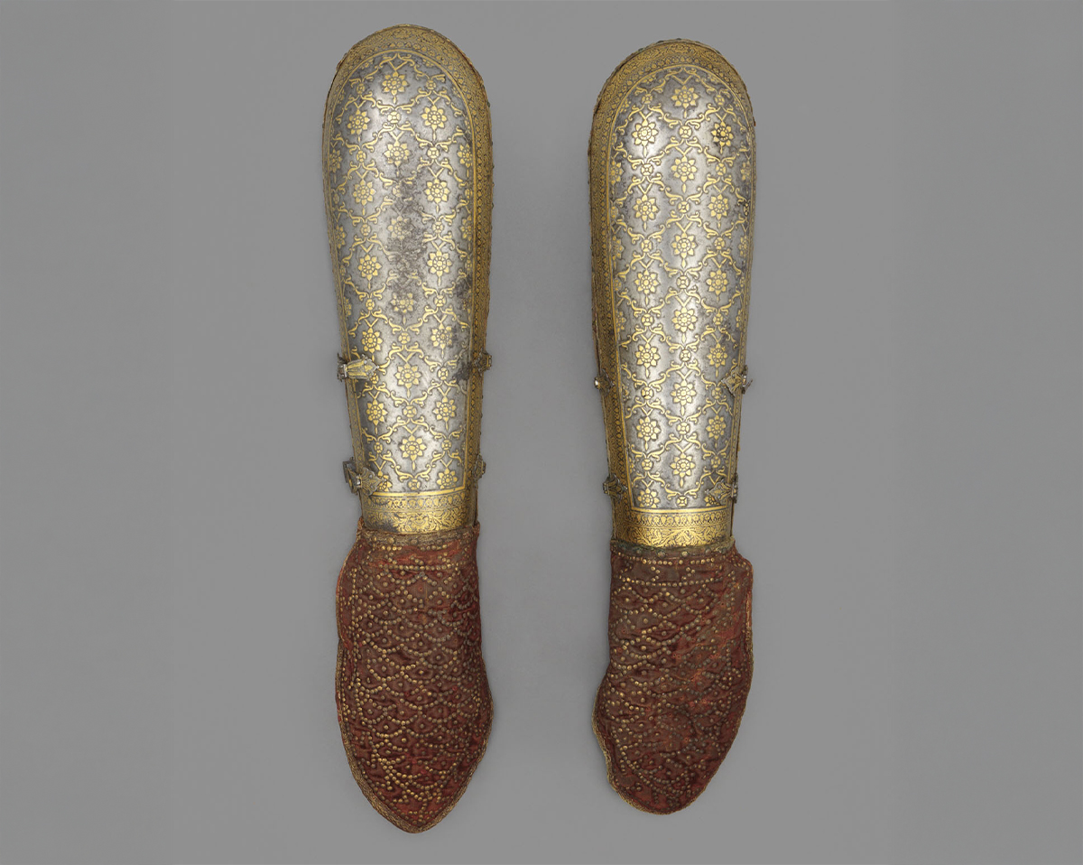 Photograph of a 18th-century bazuband made of iron or steel with gold koftgari and velvet