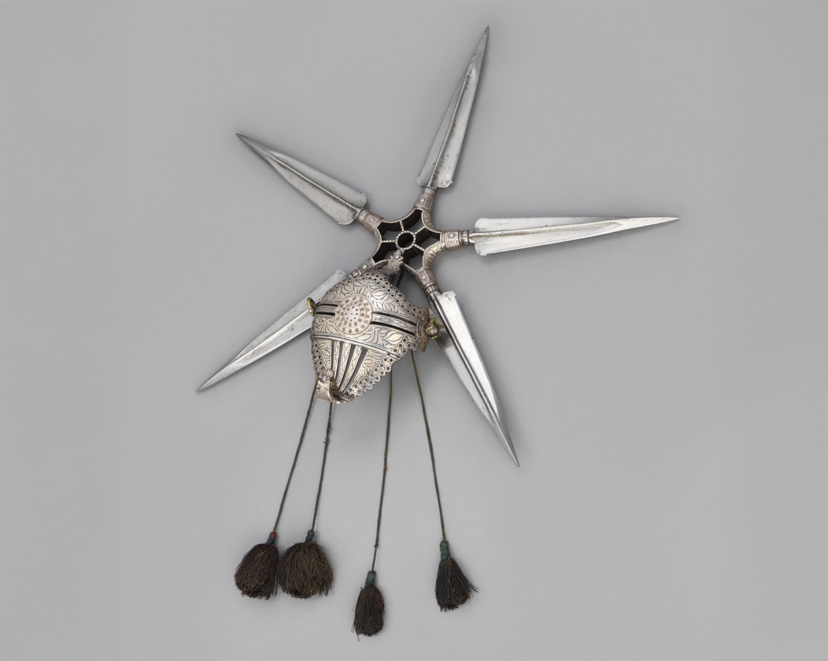 Photograph a shield radiating blades, with silver koftgari and silk tassels