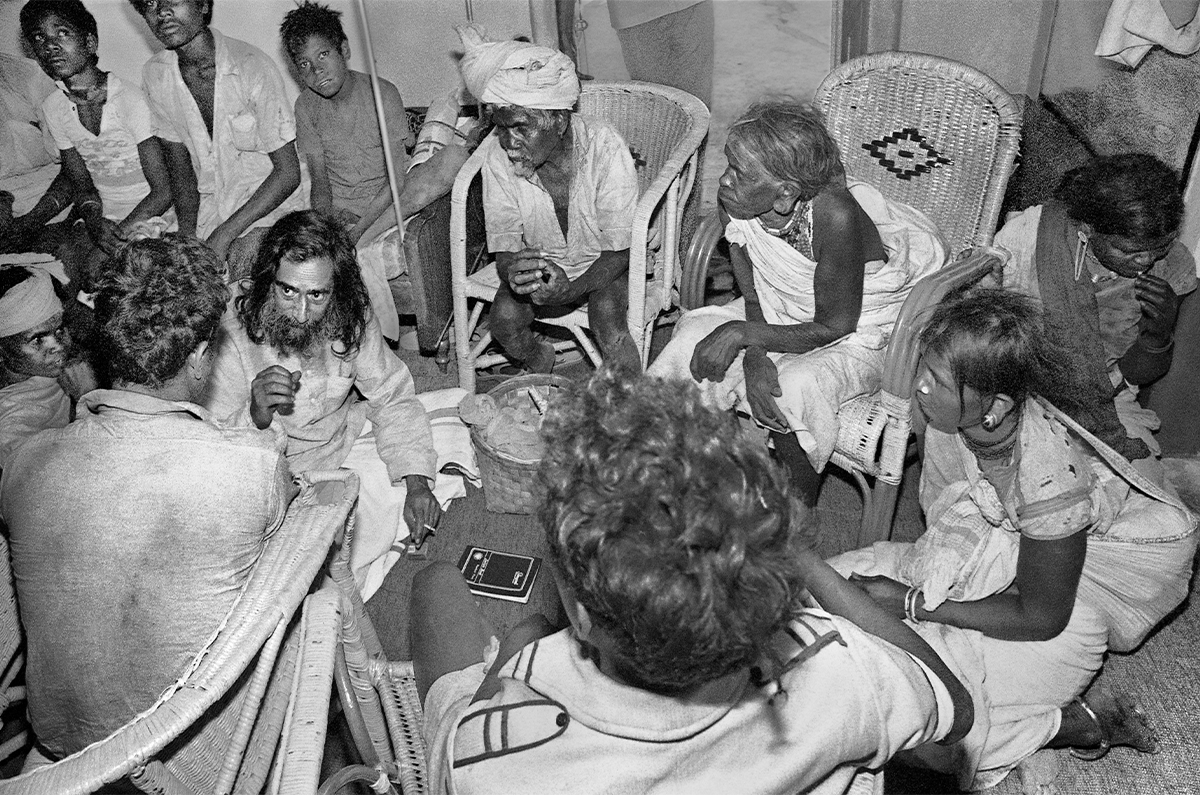 Photograph by Jyoti Bhatt of Jagdish Swaminathan seated amongst Korwa people