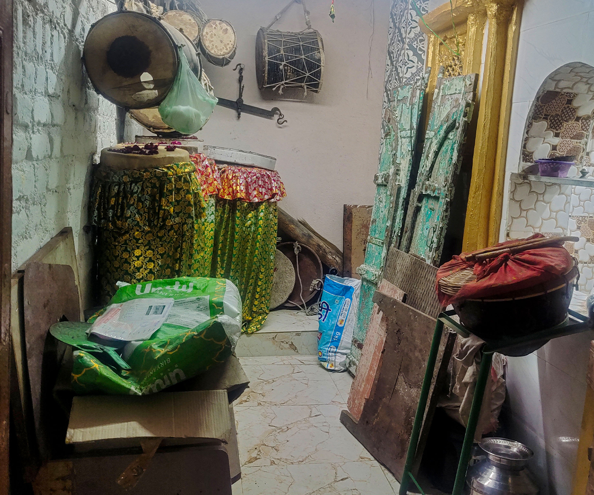 Photograph of the interior of a room housing Siddi musical instruments at the shrine of‬ Bava Gor