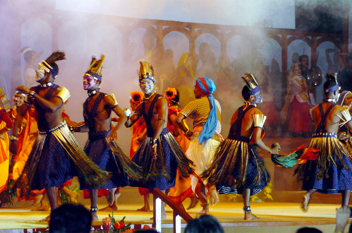 Photograph of Siddi Dhamaal perfomers on stage with other dancers