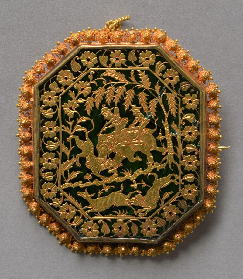 Photograph of octagonal brooch-cum-pendant with thewa on green glass showing a hunting scene within floral border and granulated rim