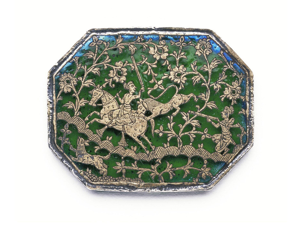 Photograph of an octagonal plaque with thewa on green glass showing a lion-hunting scene