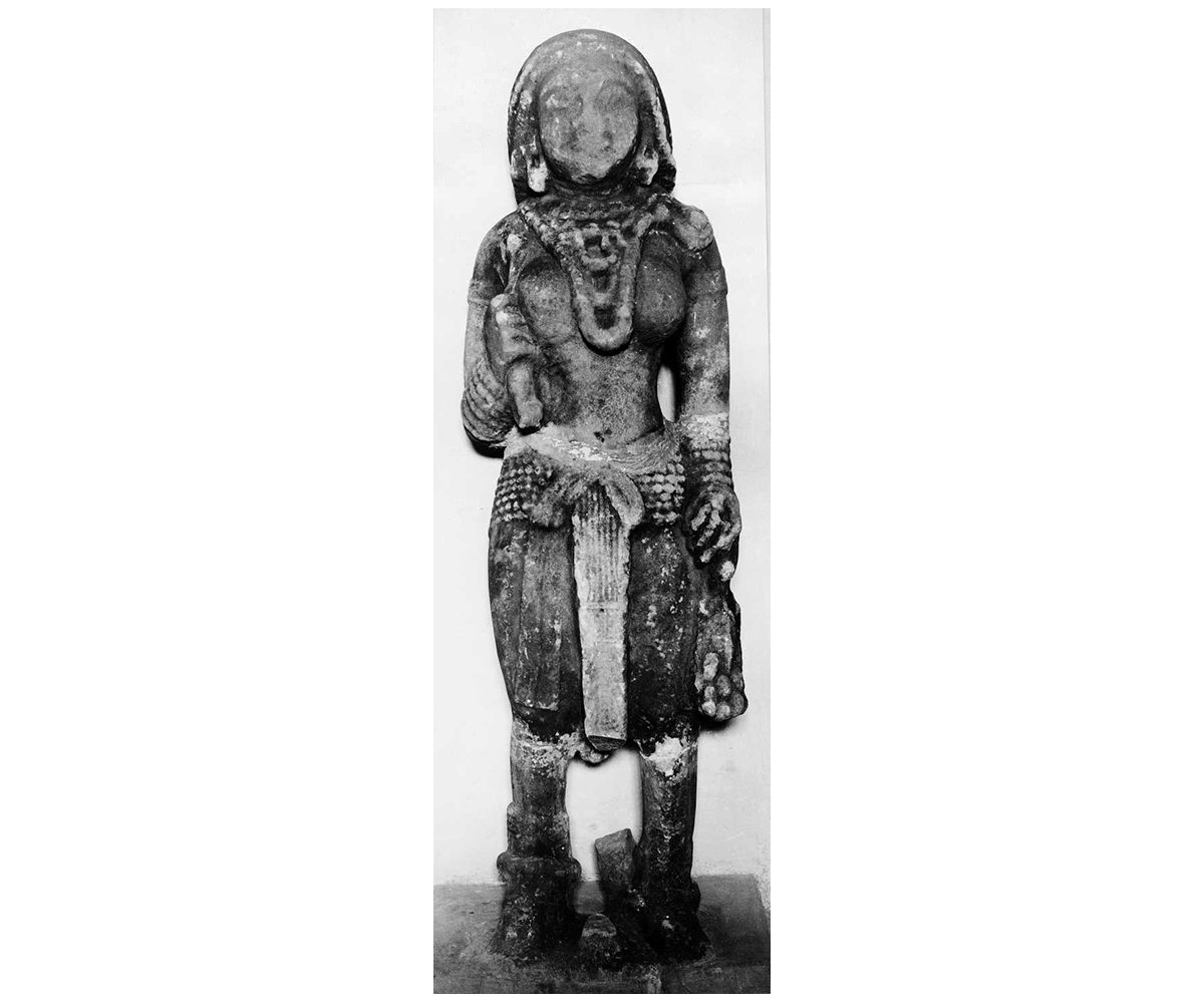 Black and white photograph of a standing sandstone yakshi from Besnagar now housed in the Vidisha Museum