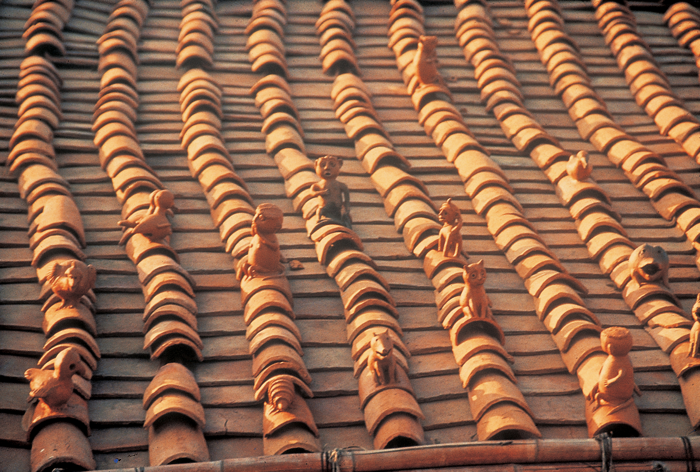 Photograph by Jyotindra Jain showing roof tiles made in the shape of mythic animals inspired from Bastaar tribal houses at National Crafts Museum in Delhi