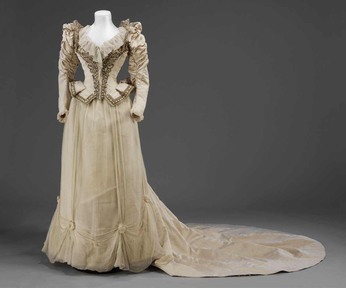 Photograph of a late-19th century wedding dress made by Francis O'Neill and of corded silk and silk crêpe chiffon