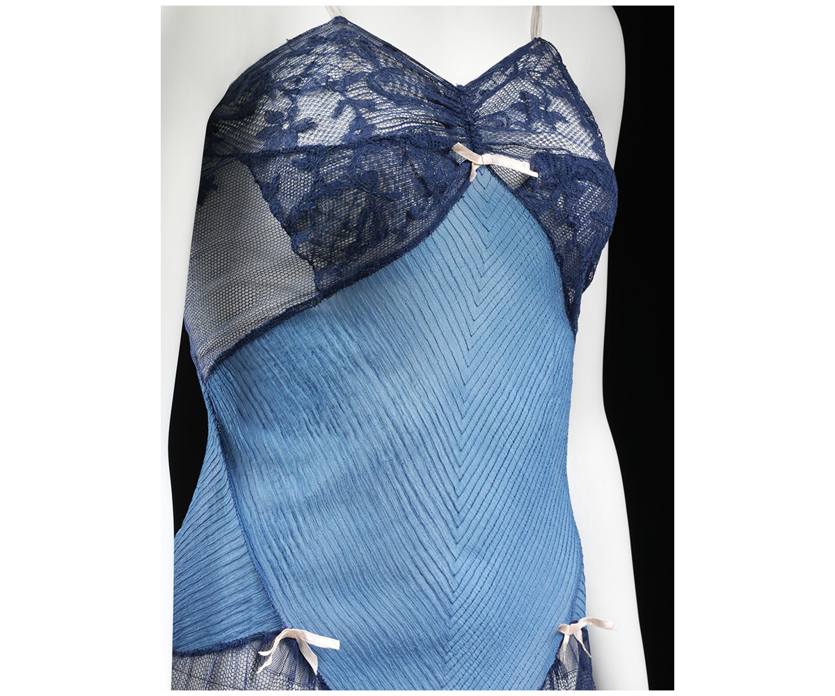 Photograph of a mid-20th century slip petticoat made up of silk crepe chiffon with machine lace