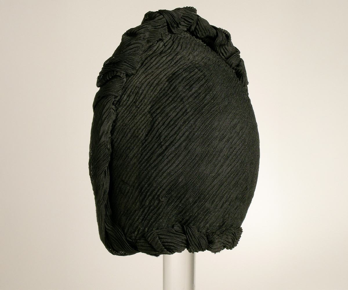 Photograph of a late-19th century woman's mourning bonnet made of silk crepe