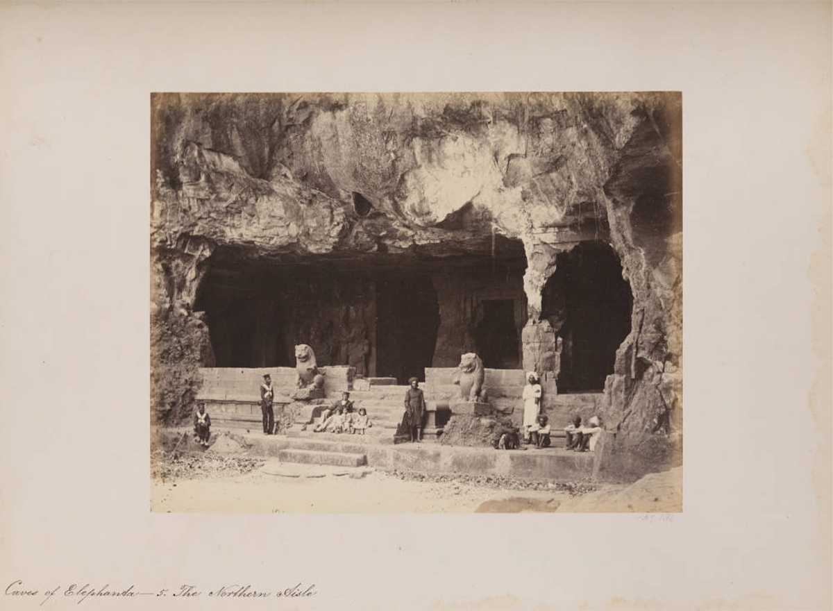 Mid-19th century photograph by William Johnson showing men standing before the northern aisle of Elephanta Cave 5