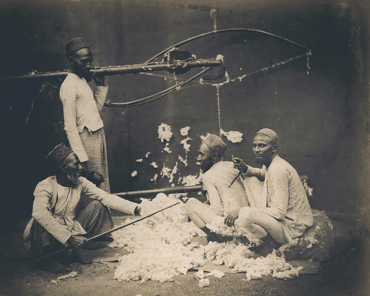 Mid-19th-century archival photograph by William Johsnon showing a group of men spinning cotton