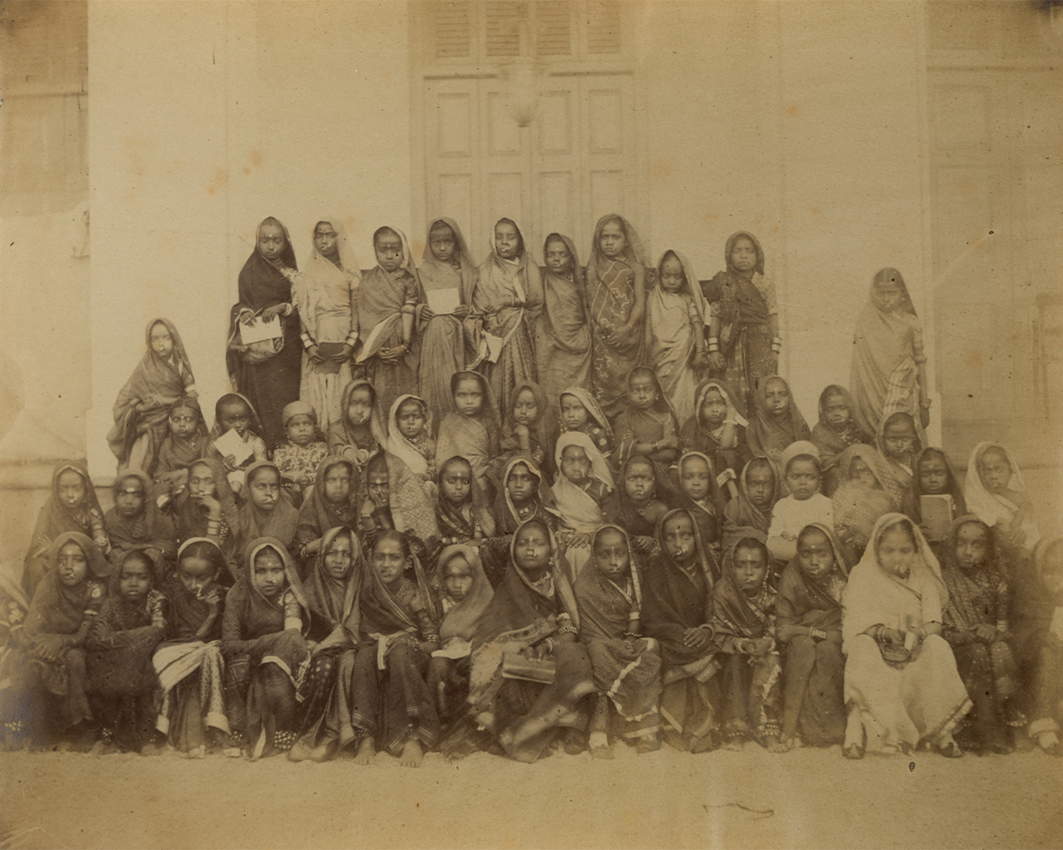Mid-19th-century archival photograph by William Johsnon showing a group of girl students in Bombay