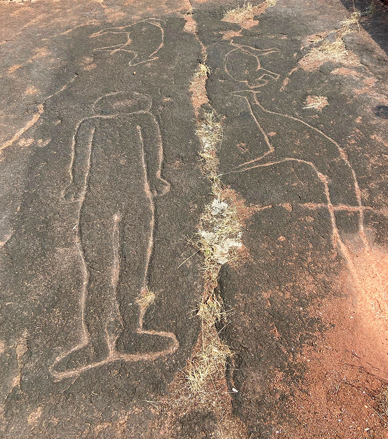 Photograph of petrogylphs at Ganpatipule showing a standing human figure and animals