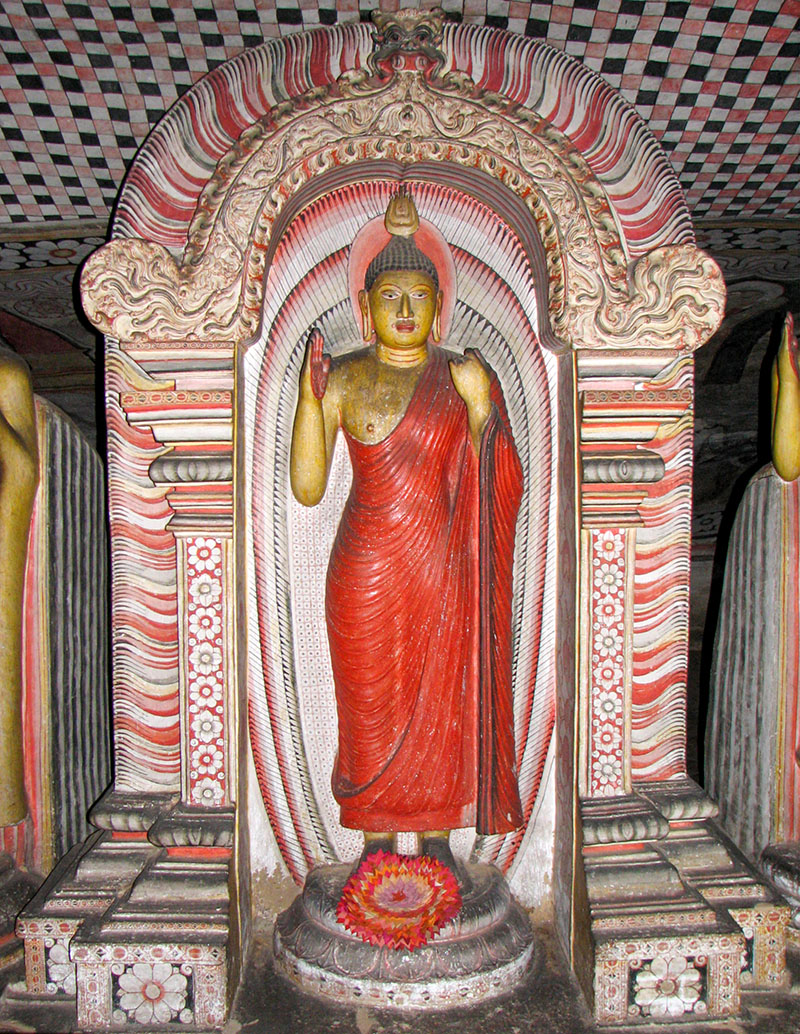 Photograph of a standing Buddha inside the Dambulla Caves