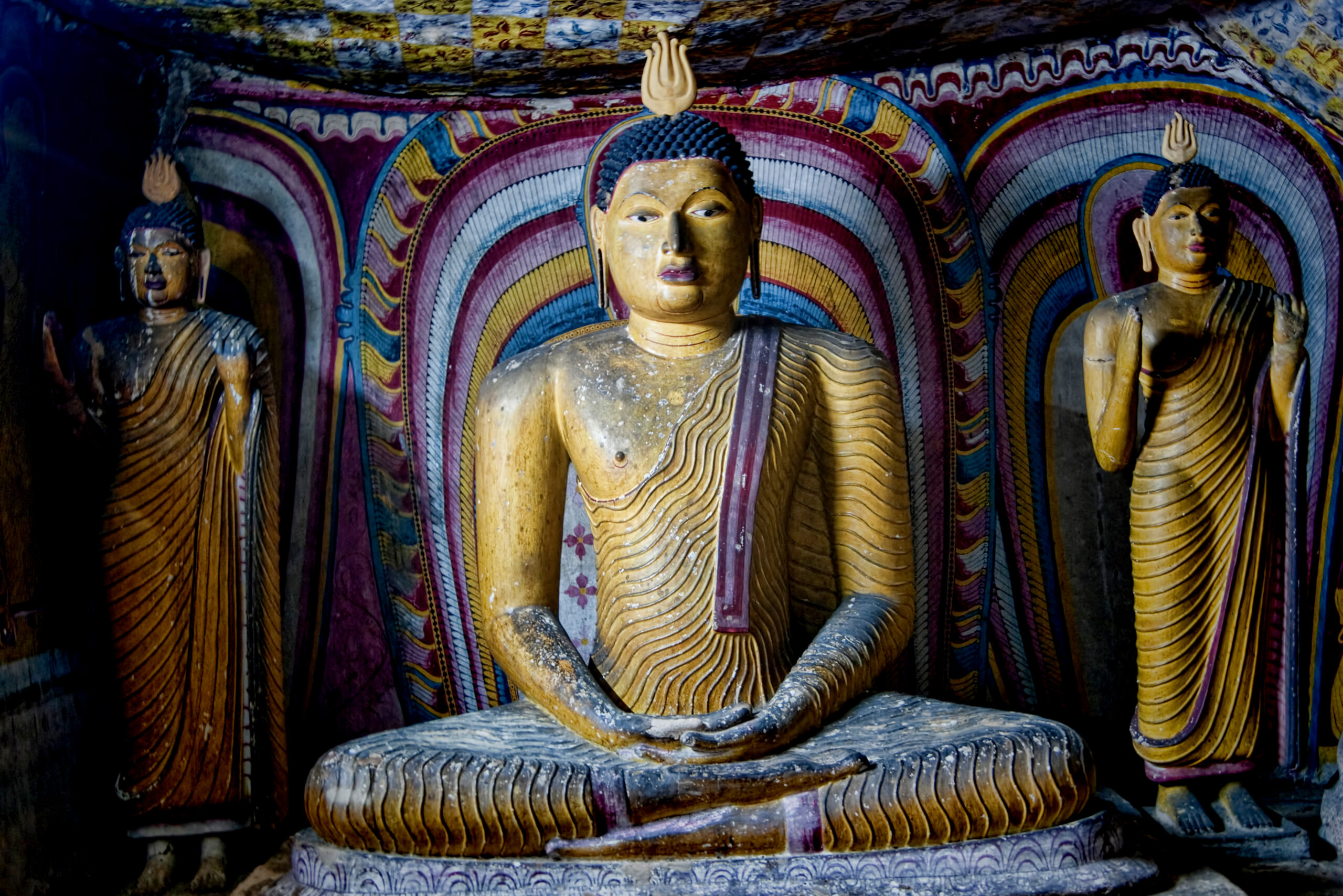 Photograph of a seated Buddha inside the Dambulla Caves