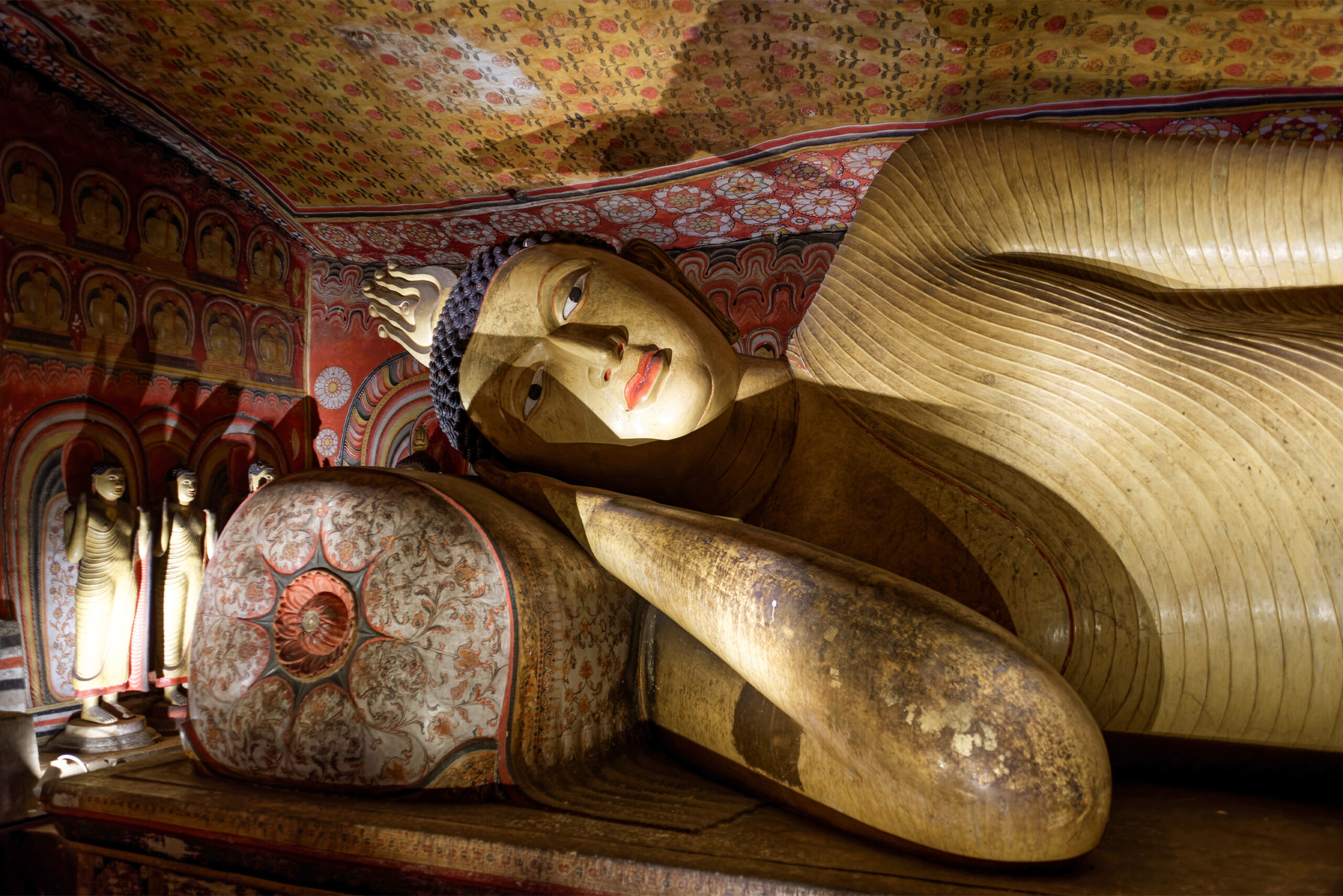 Close-up photograph of a reclining Buddha inside the Dambulla Caves