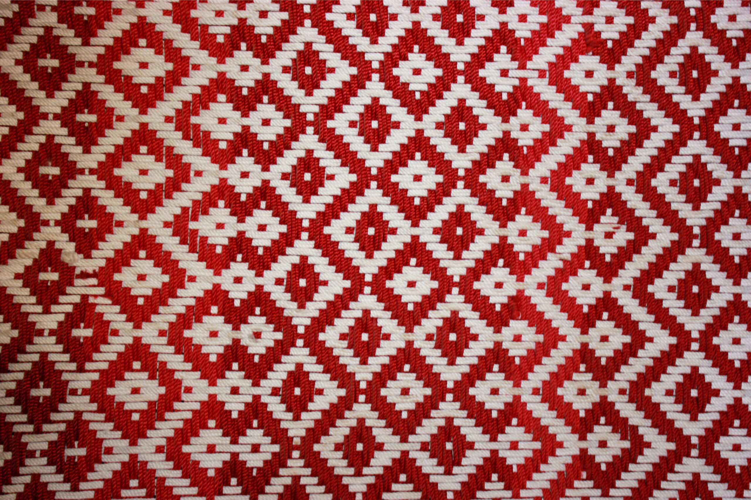 Close-up photograph of the webbing of a Singhadu macha with the pattern resembling a stepwell