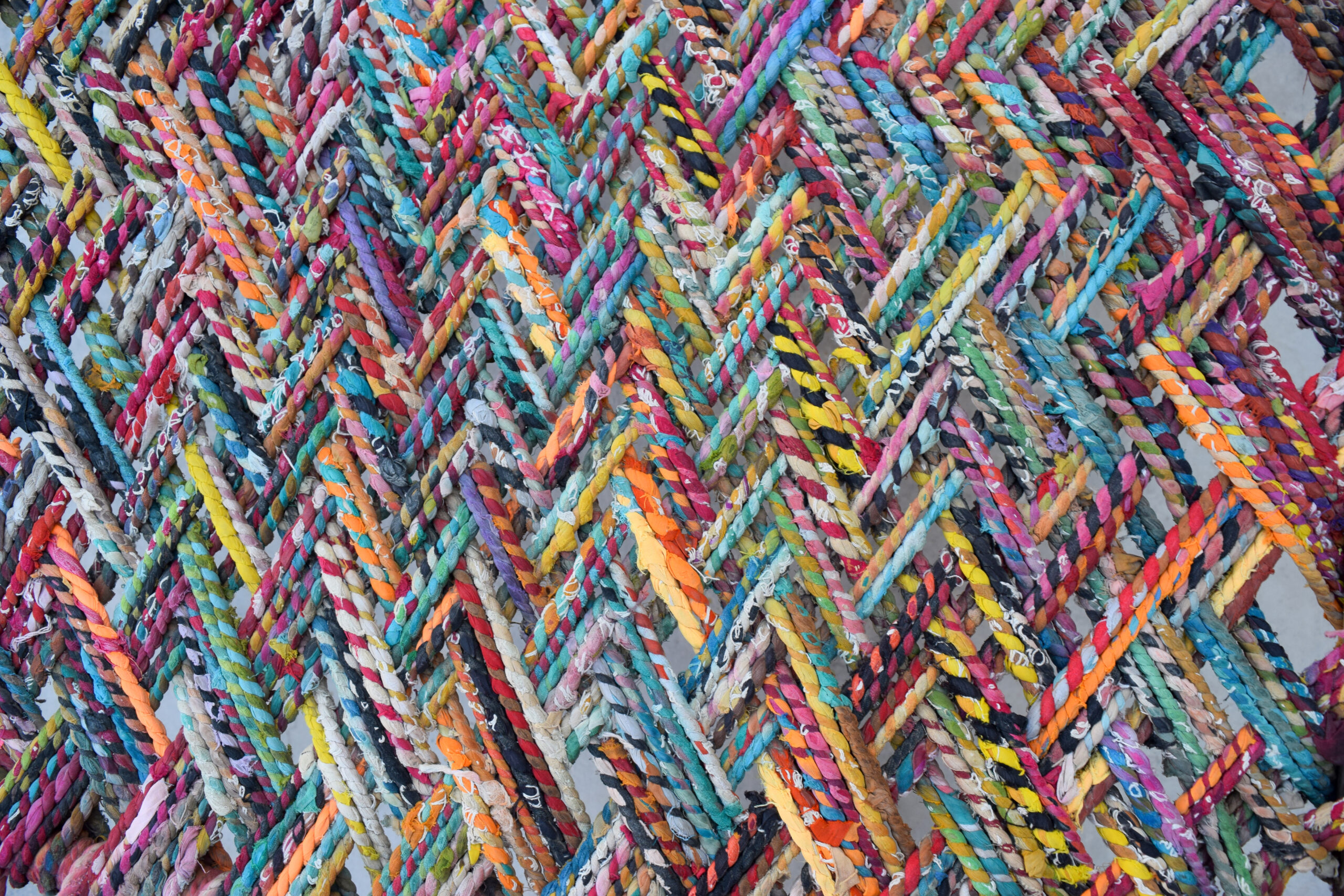 Close-up photograph of the webbing of a charpoy made of shredded textiles