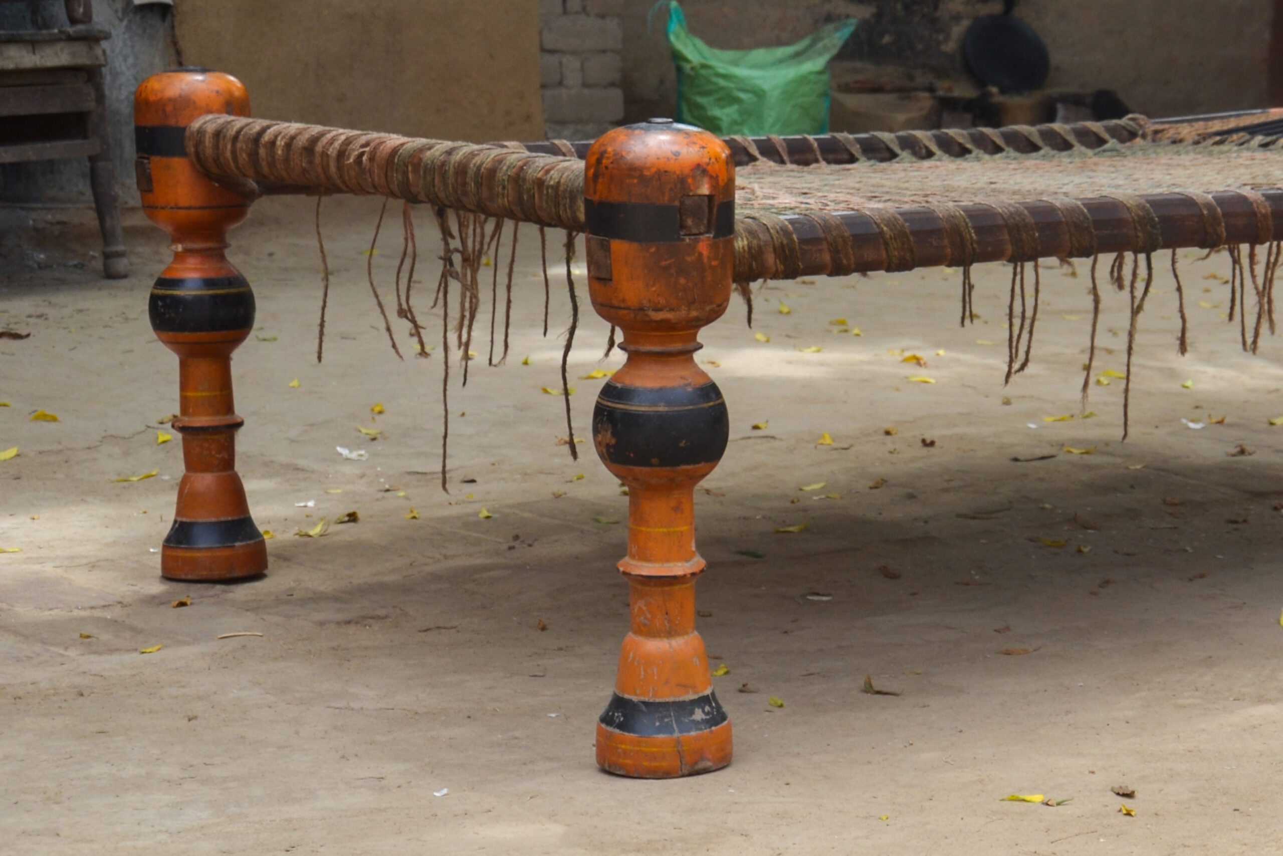 Photograph of a charpoy with turned and lacquered wooden legs