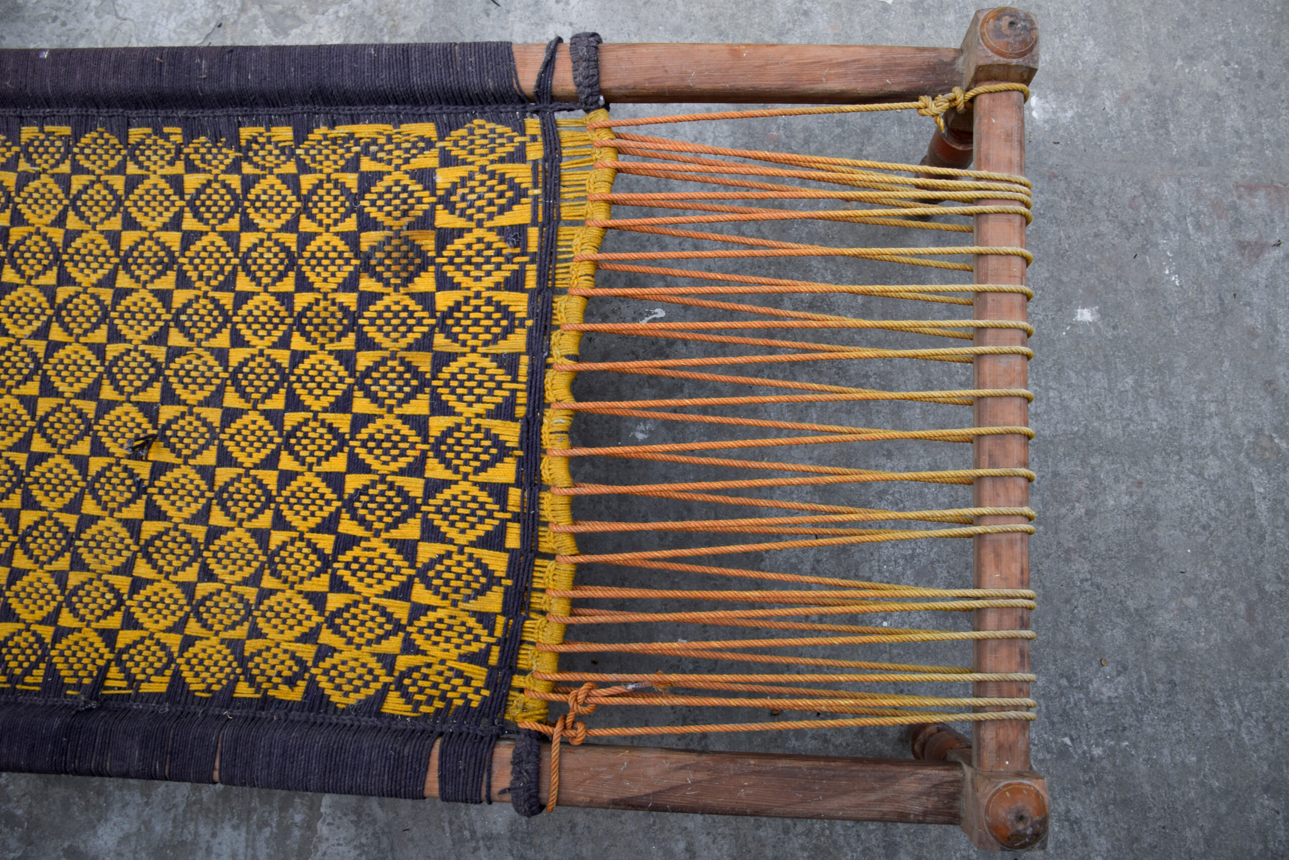 Close-up photograph showing the webbing of a charpoy