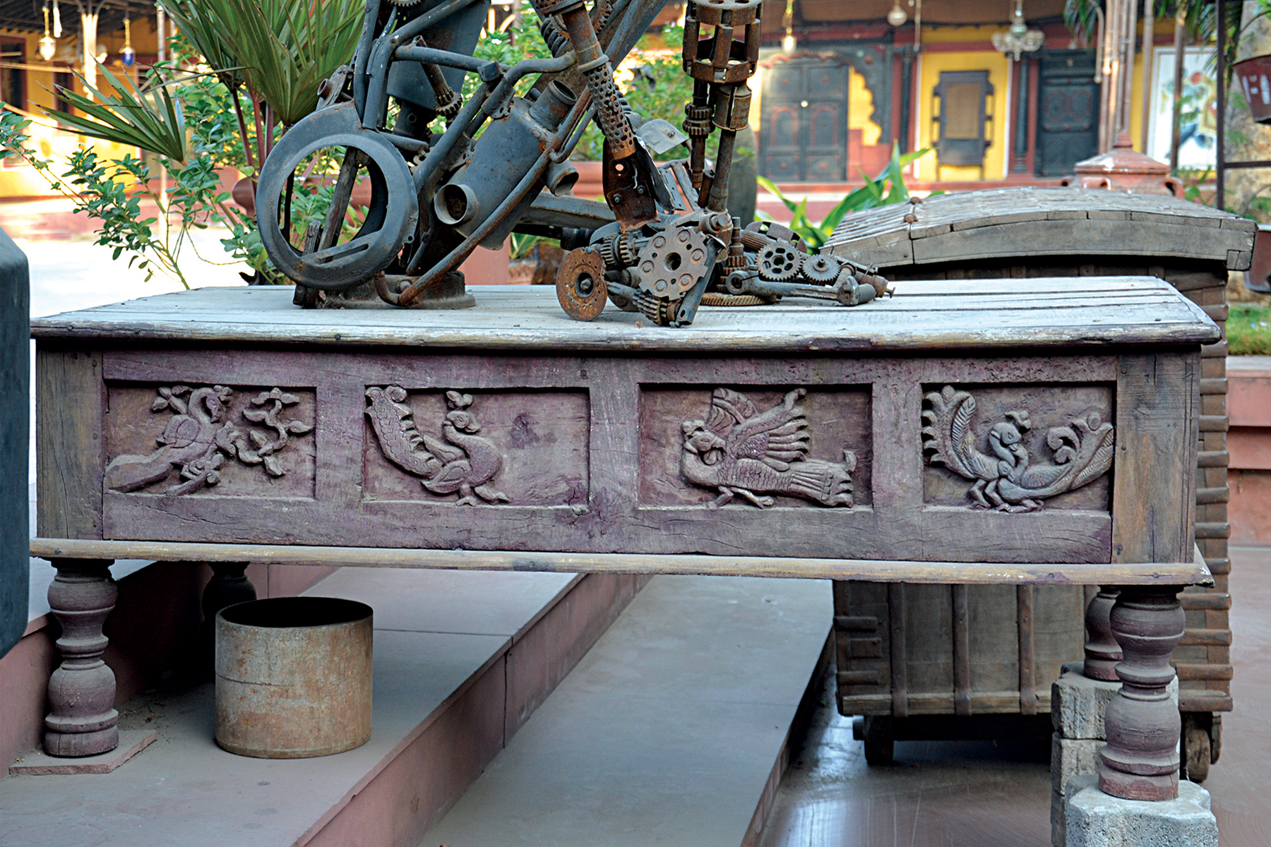 Photograph of various peacock motifs carved on the side of a paat