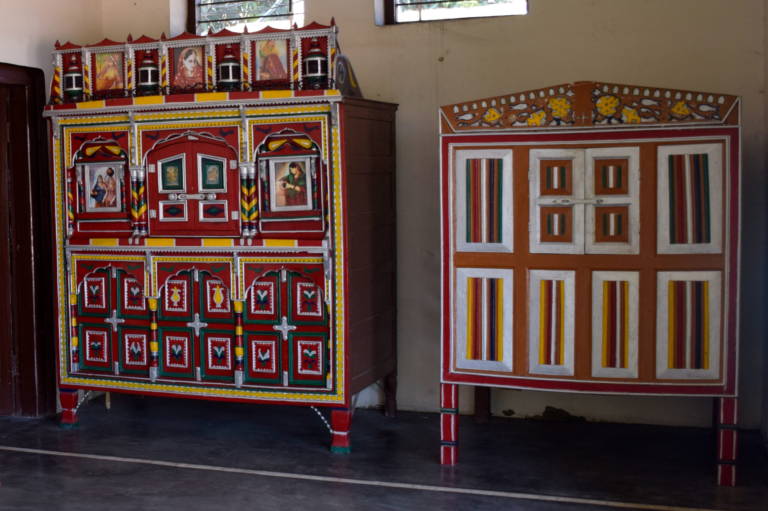 Photograph of a pair of sandook in the verandah of a house