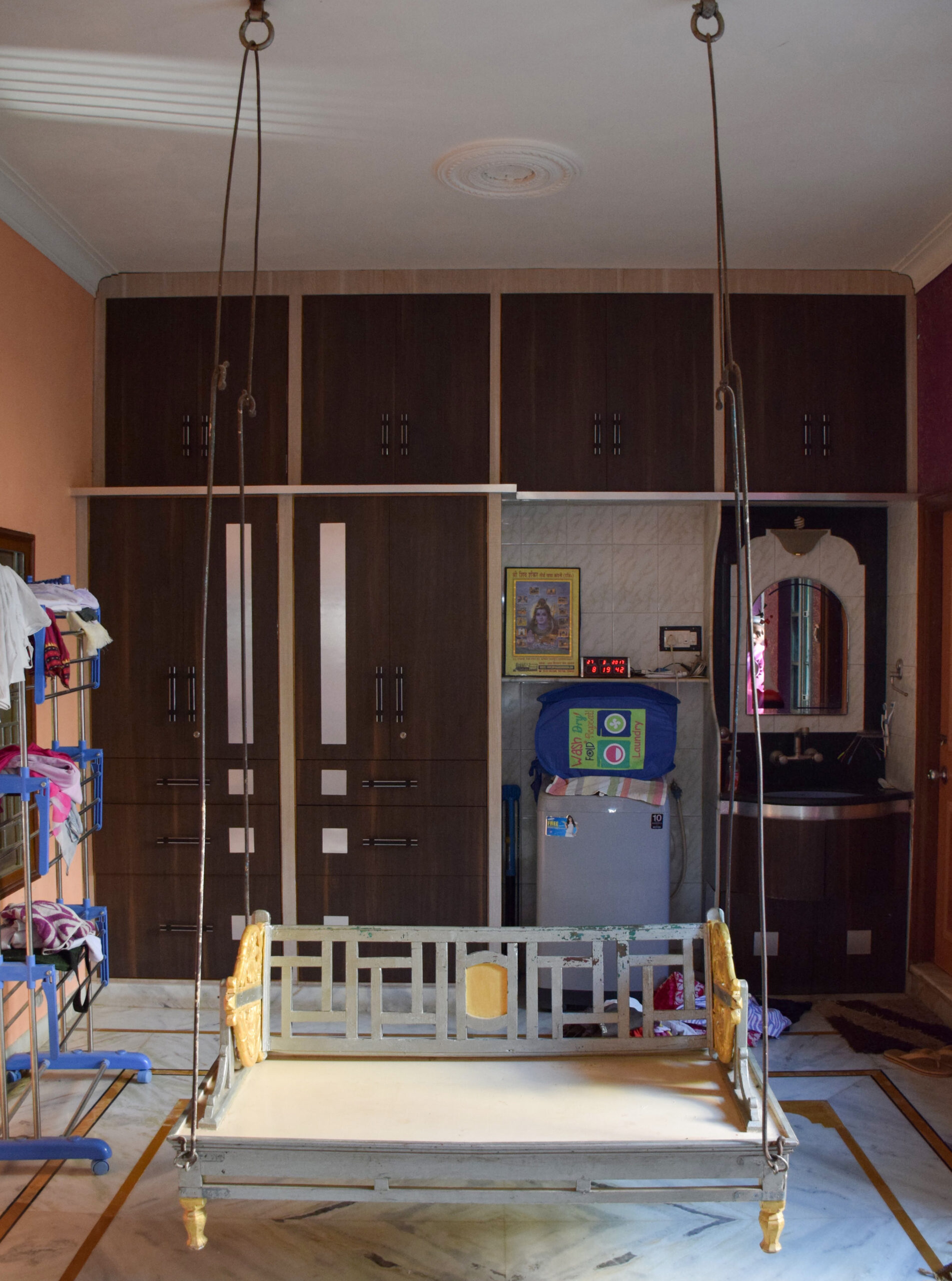 Photograph of a swing suspended from the roof of a house known as jhula