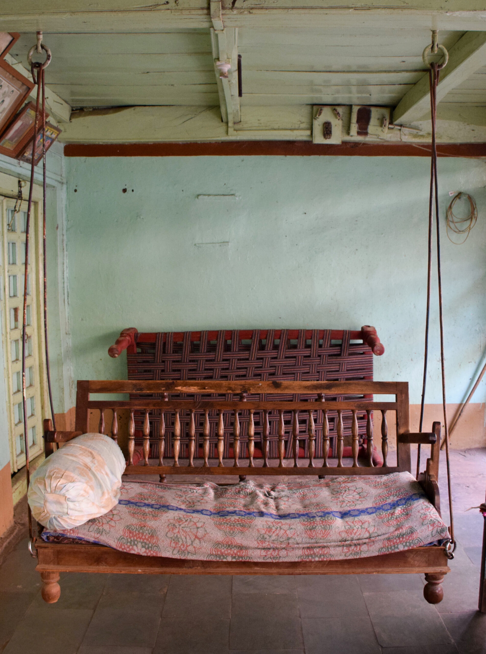 Photograph of a swing suspended from the roof of a house known as jhula