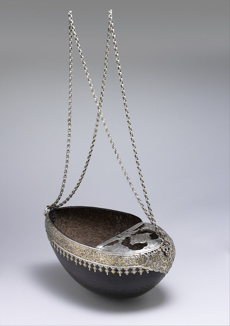 Photograph of a 18th century Irani kashkul attributed to Yar Muhmmad made of coco-de-mer shell and silver