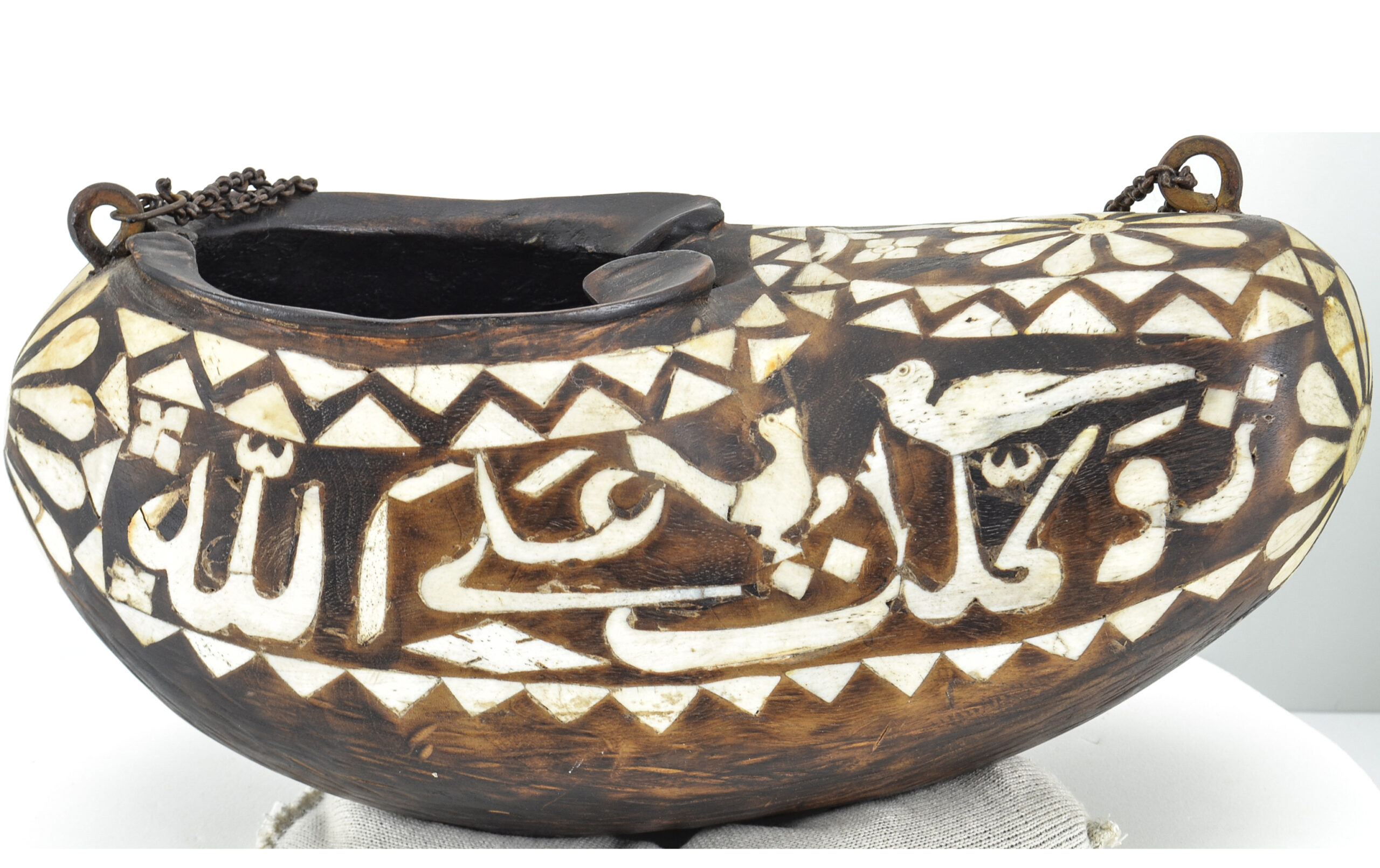 Photograph of a late 19th to early 20th century wooden kashkul inlaid with camel bone
