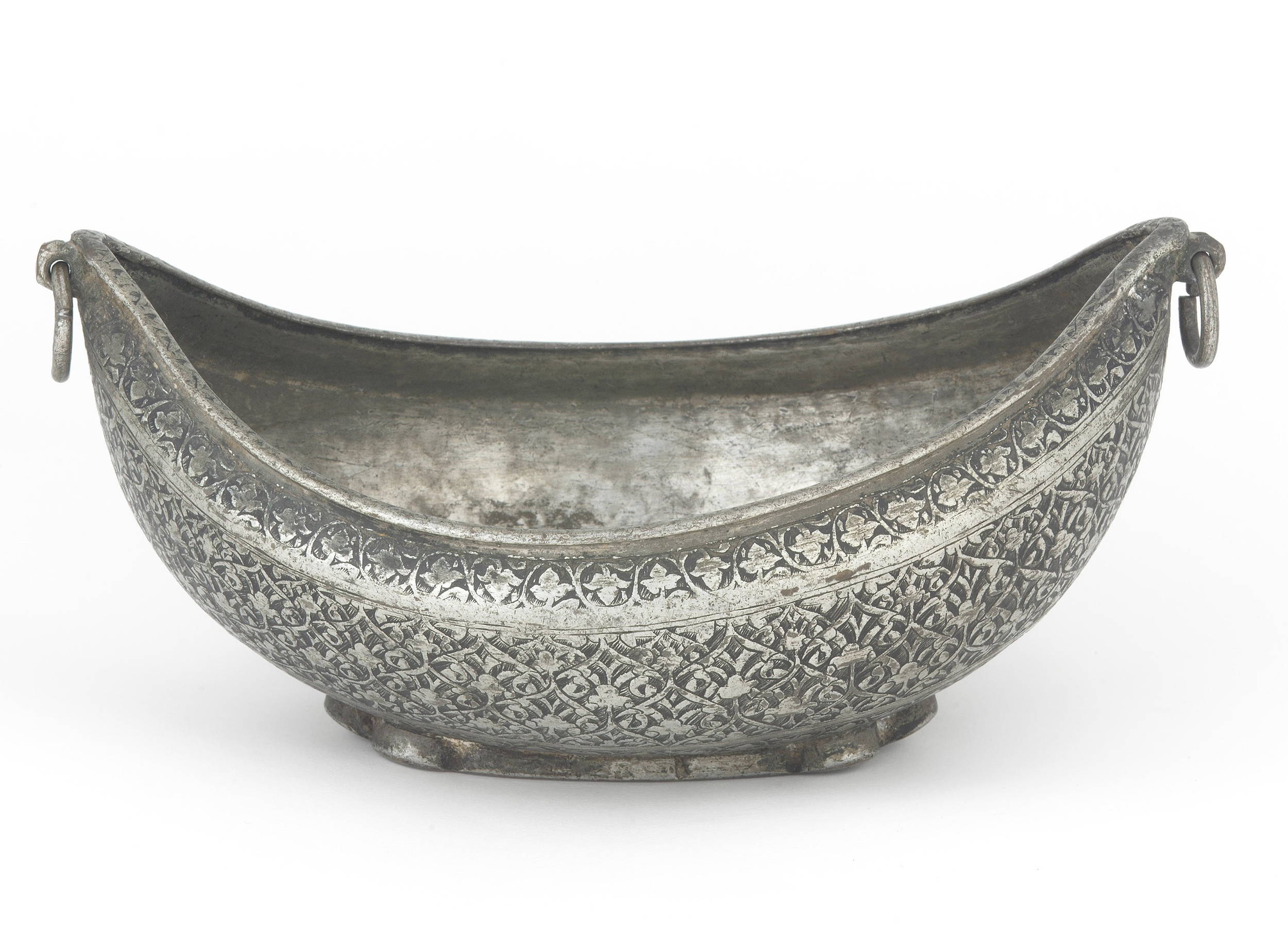Photograph of a 19th century kashkul from either Iran or Afghanistan made of tinned brass