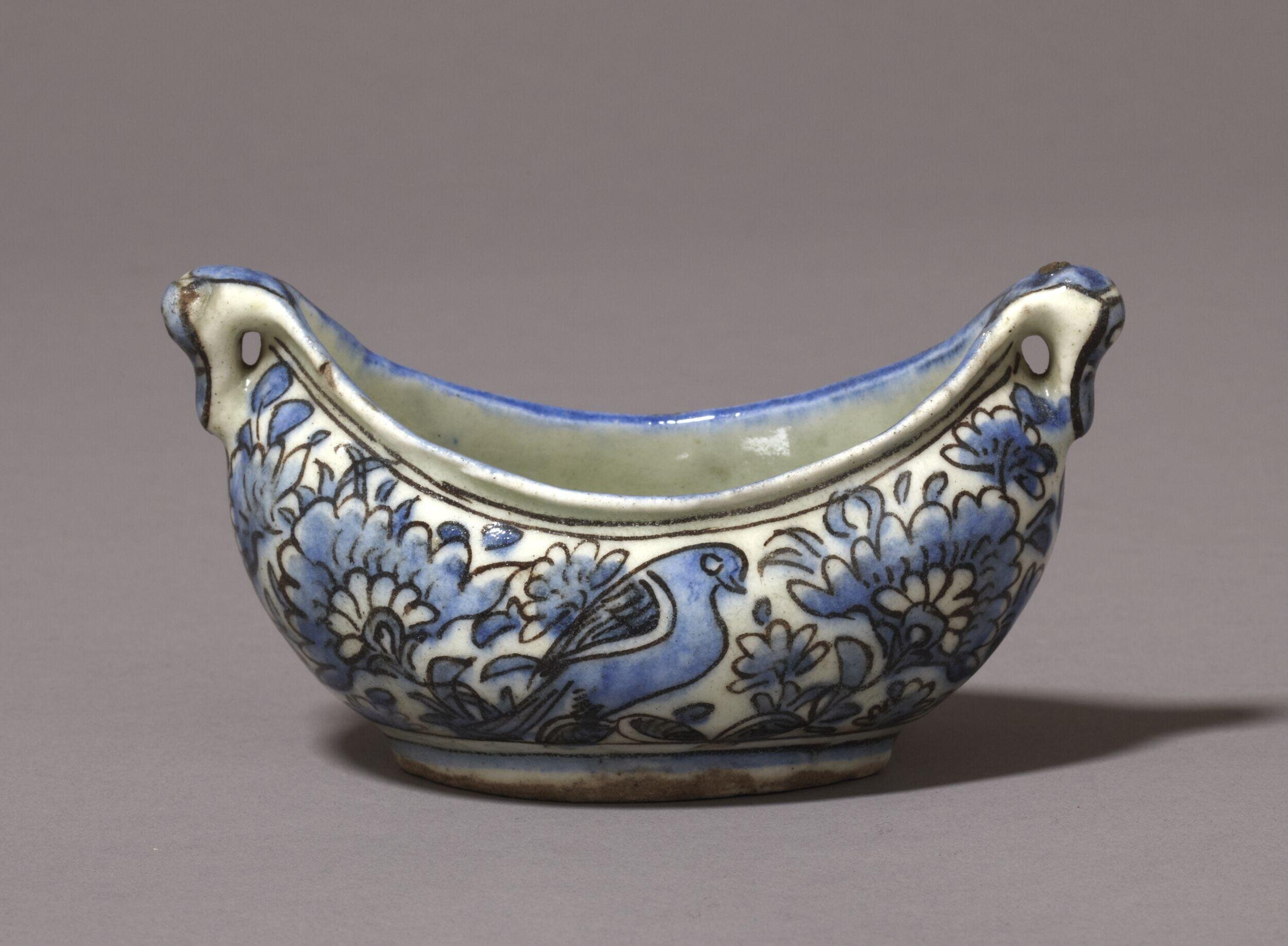 Photograph of a 17th century ceramic kashkul painted in blue from Iran