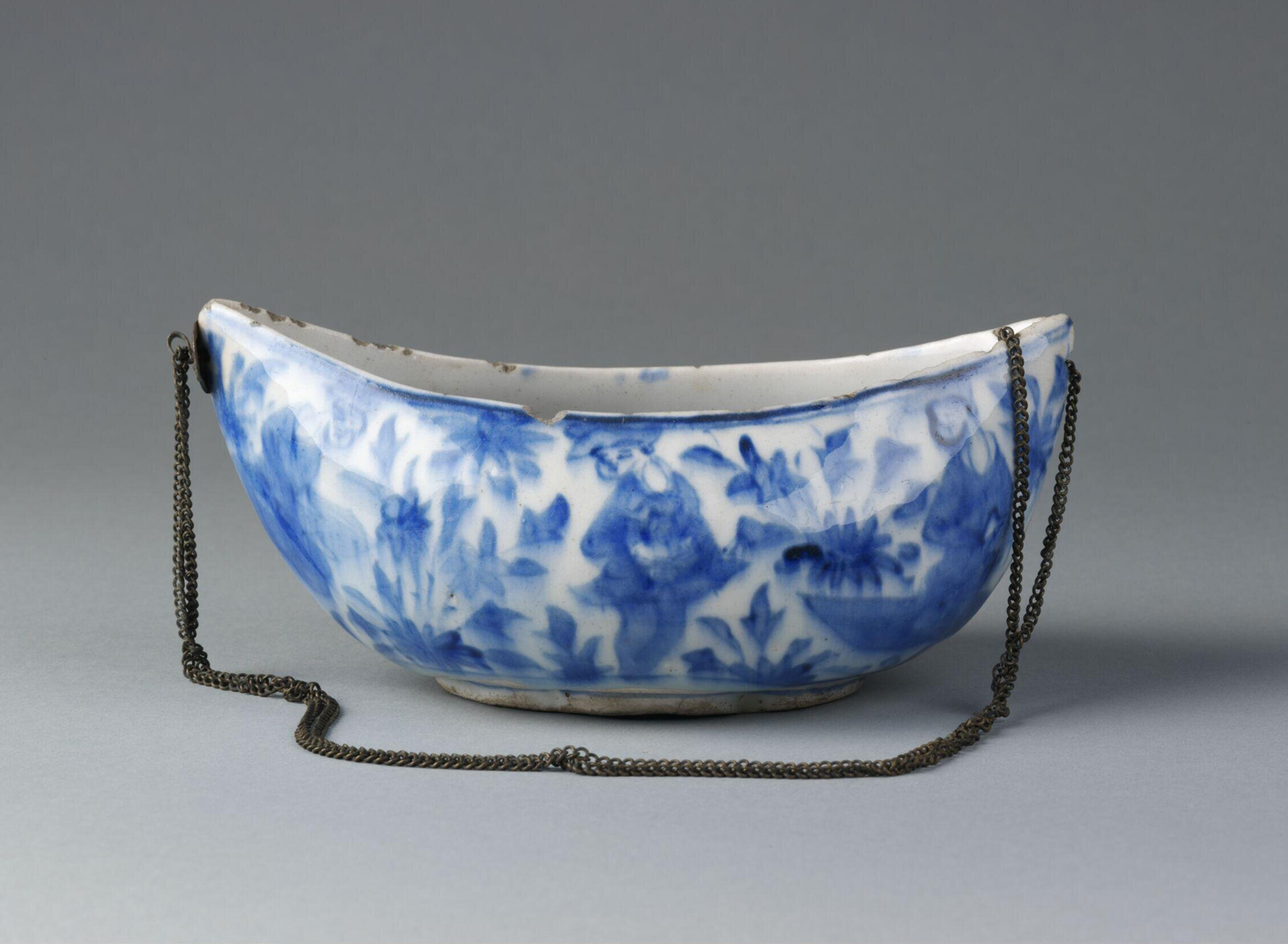 Photograph of a 17th or 18th century ceramic kashkul painted in blue from Iran