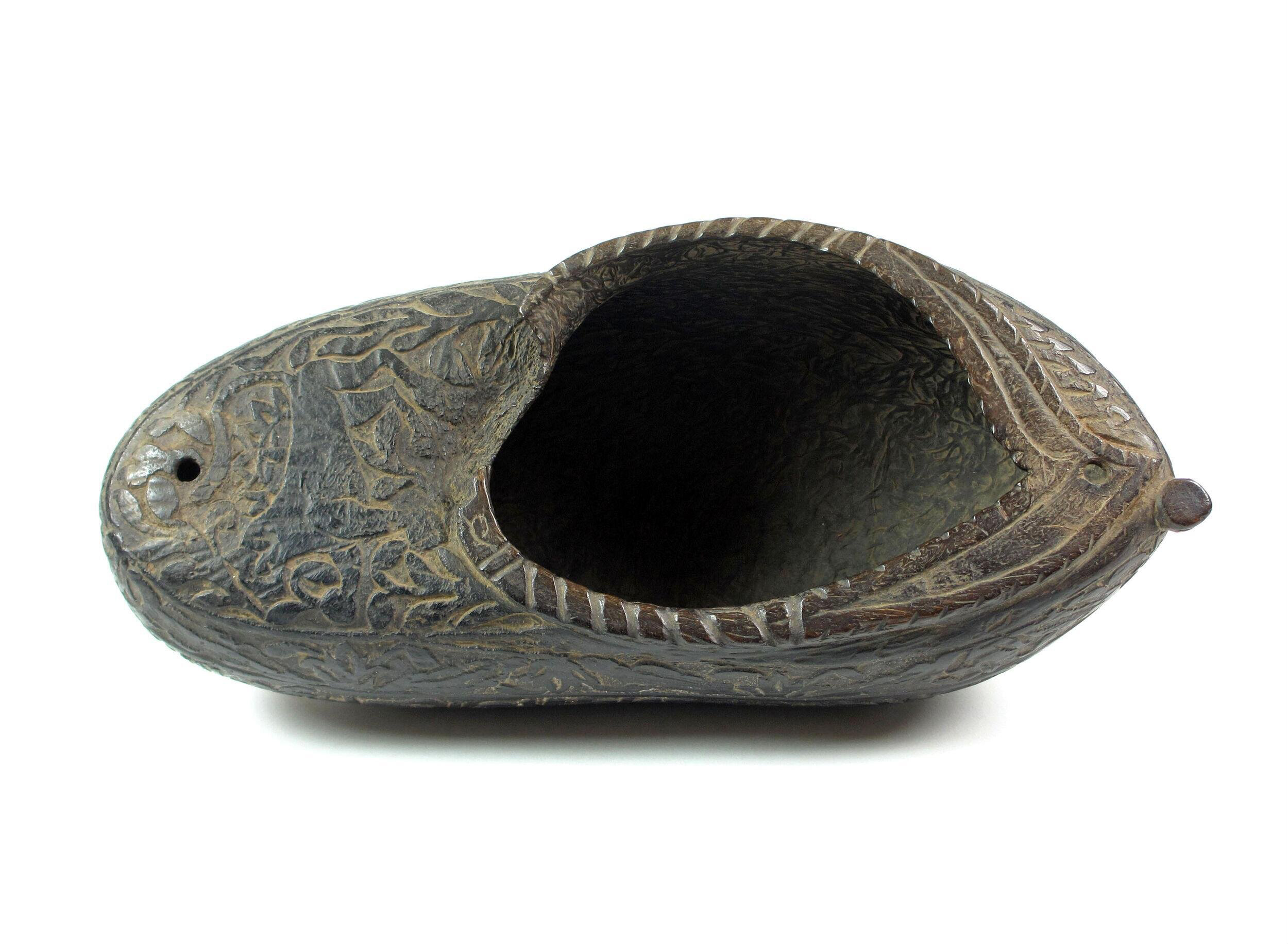Photograph of a carved coco-de-mer shell kashkul dated to the Qajar period in Iran