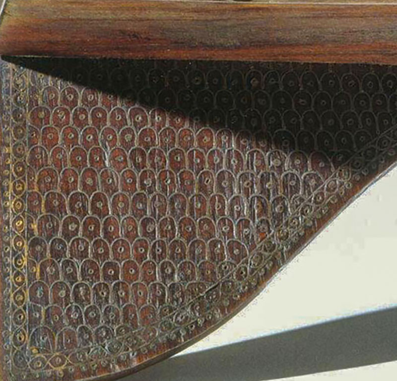 Photograph of a late 19th to early 20th book rest from Manipur made out of shisham wood and inlaid with brass wire