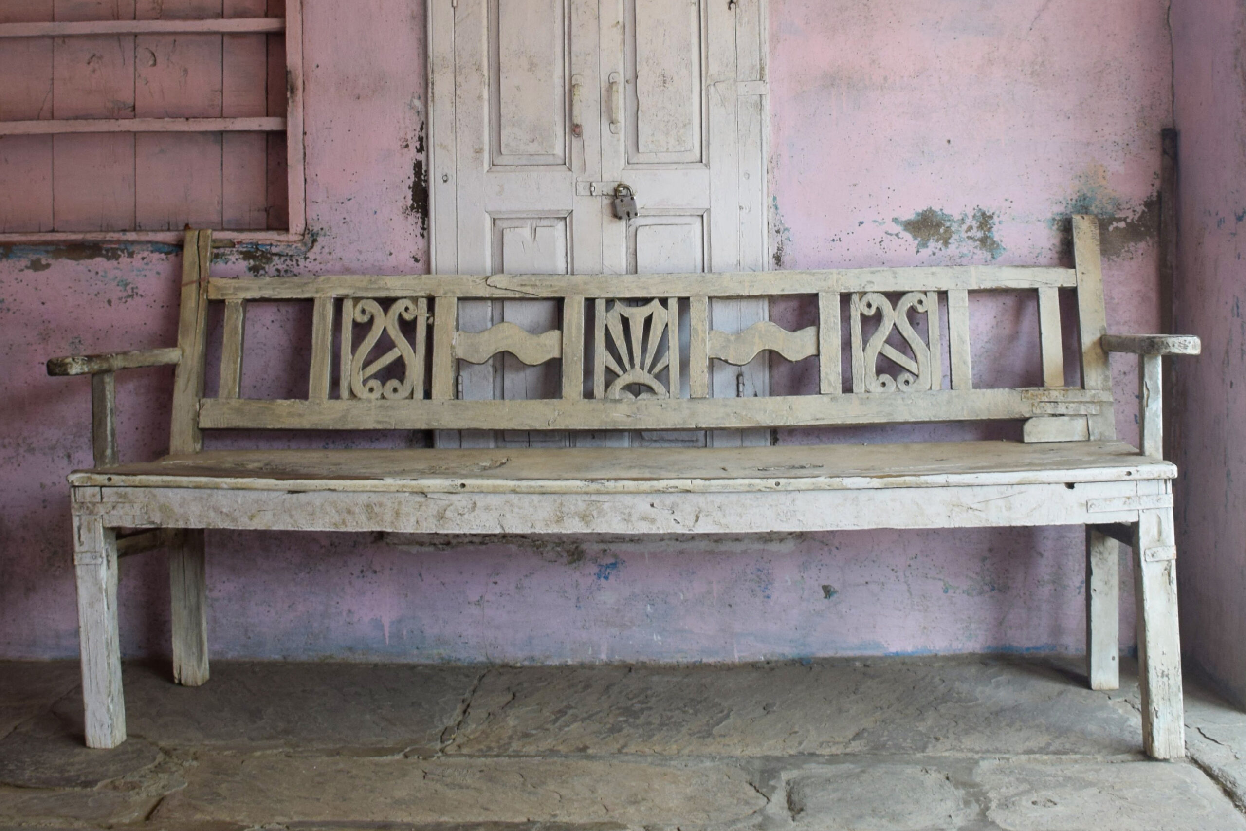 Photograph of a large wooden bench with backrest and armrests called a bankdo from Banswara, Rajasthan