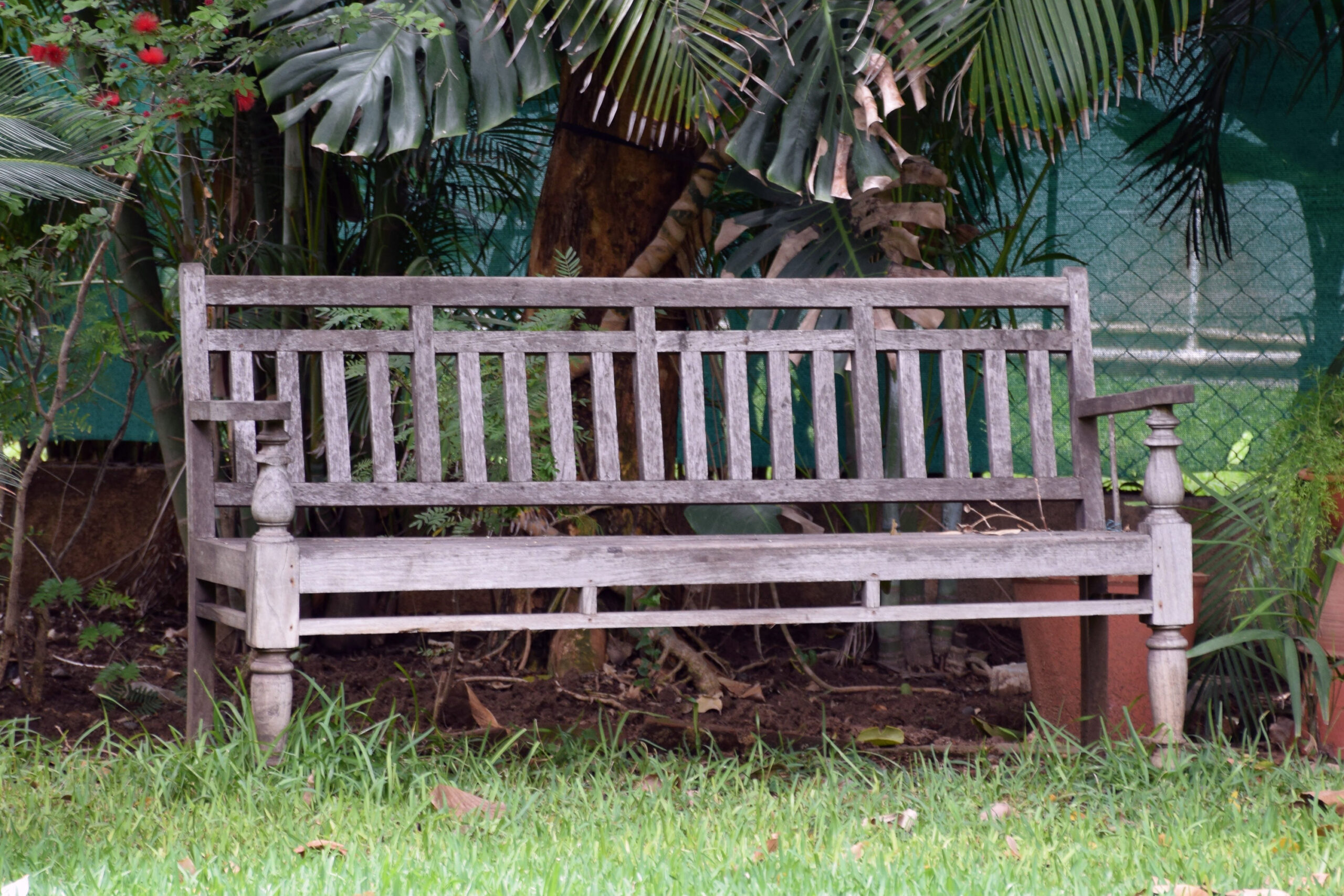 Photograph of a large wooden bench with backrest and armrests called a bannk from Valsad, Gujarat